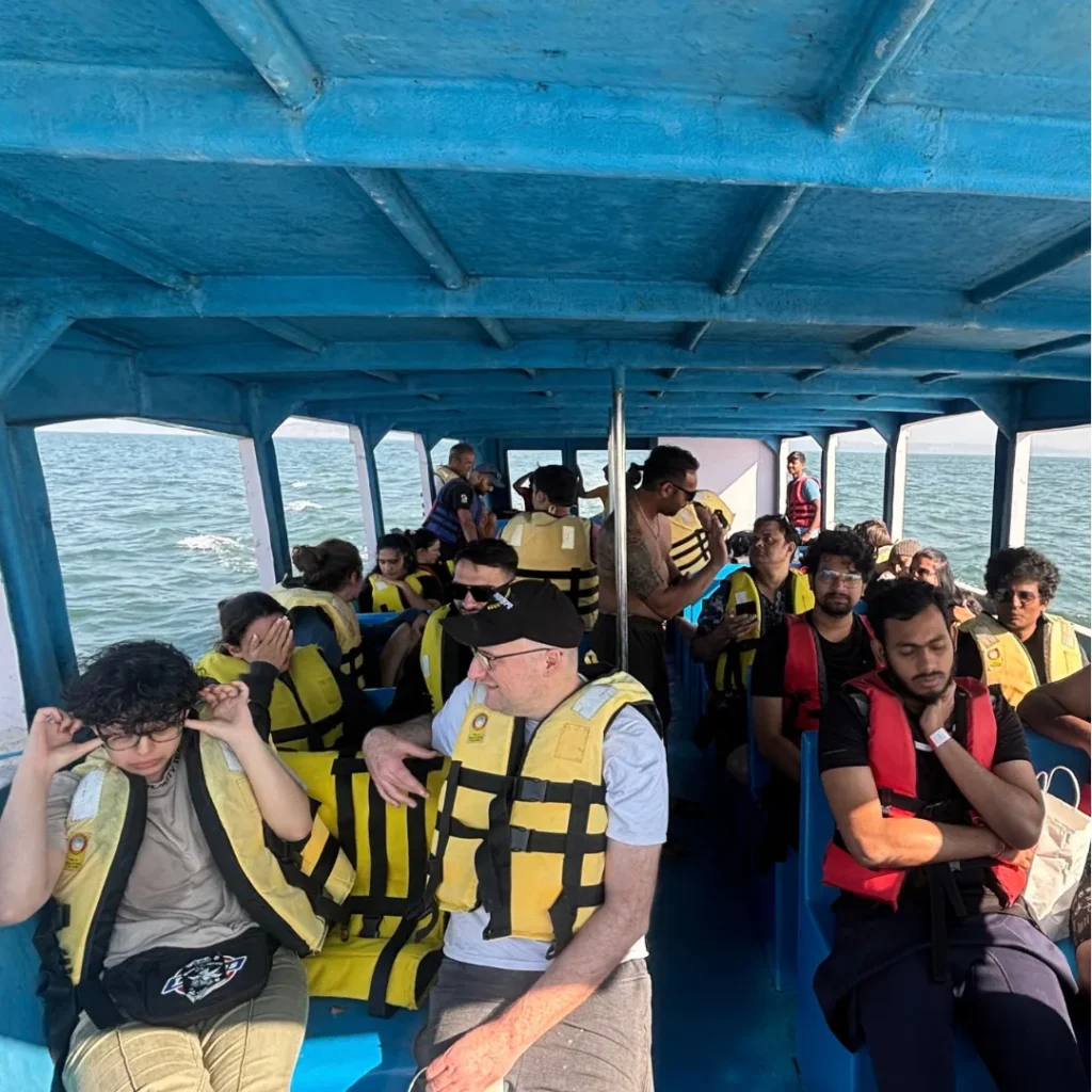 Guests in life jackets on the FlyingFish dive boat heading to Grande Island, Goa