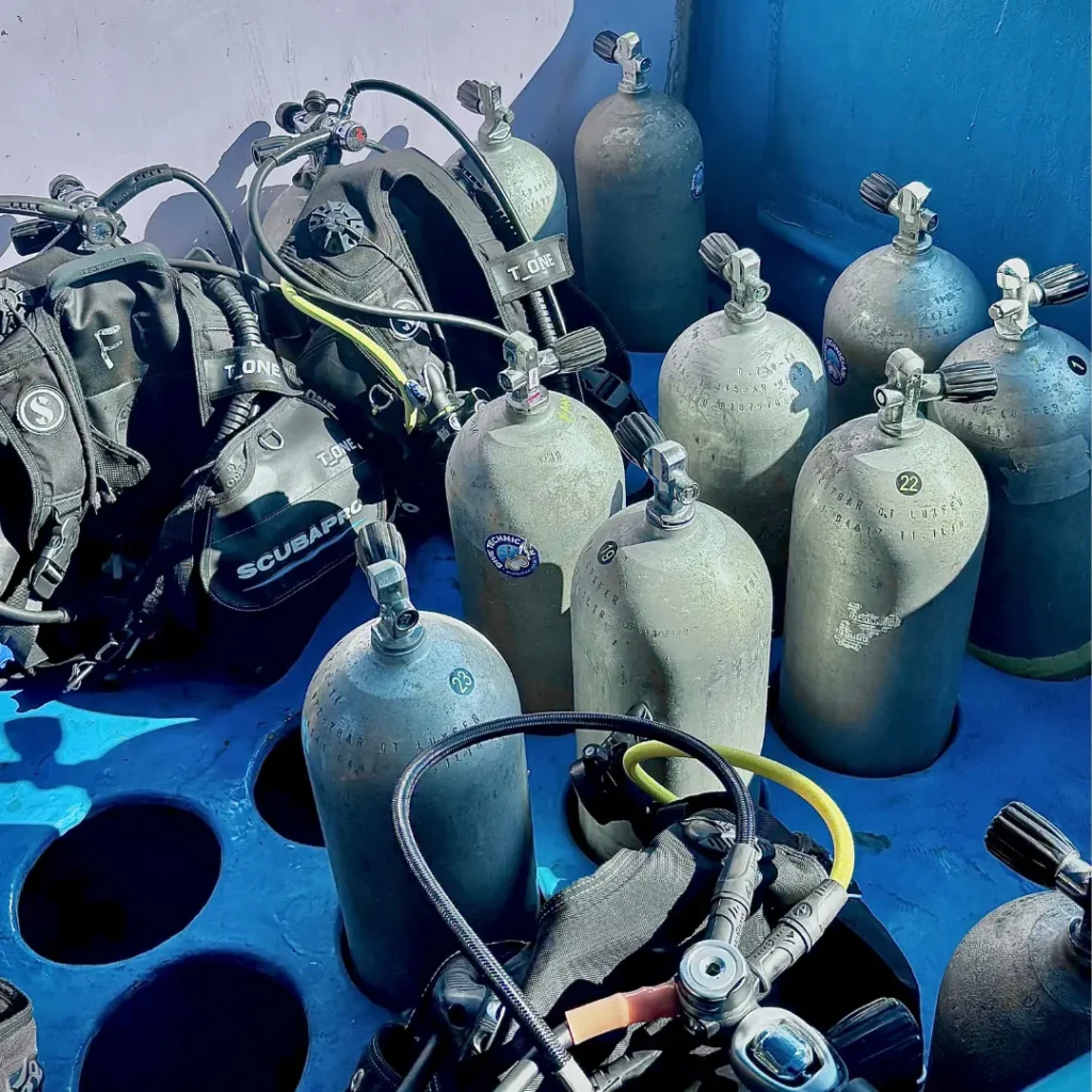 Scuba tanks, regulators and BCDs ready on the FlyingFish dive boat in Goa