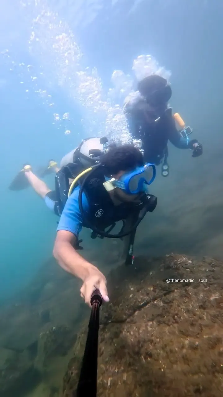 Divers exploring the rocky reef off Grand Island in a first-person dive video