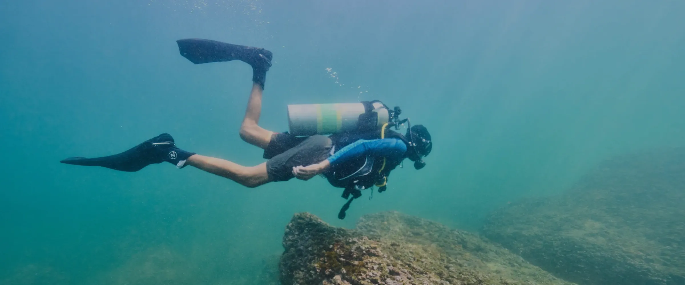 Scuba diving in Goa: a FlyingFish diver glides over the reef at Grand Island