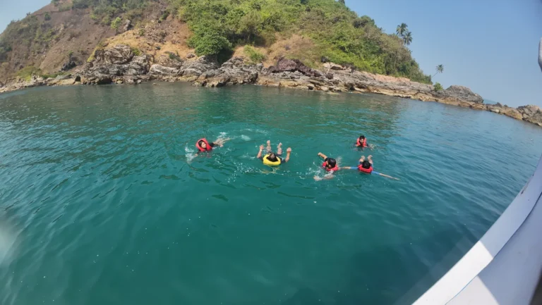 Snorkelers in life jackets floating near the rocks at Grand Island